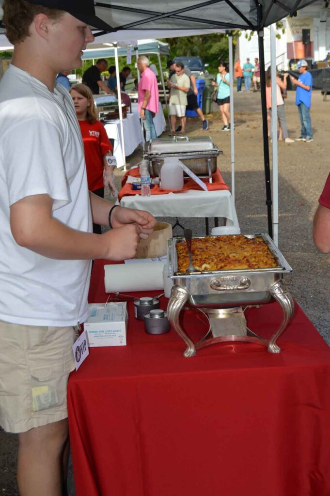 Vendor handing out samples for the Mac n Cheese competition at the Camden BBQ Fest