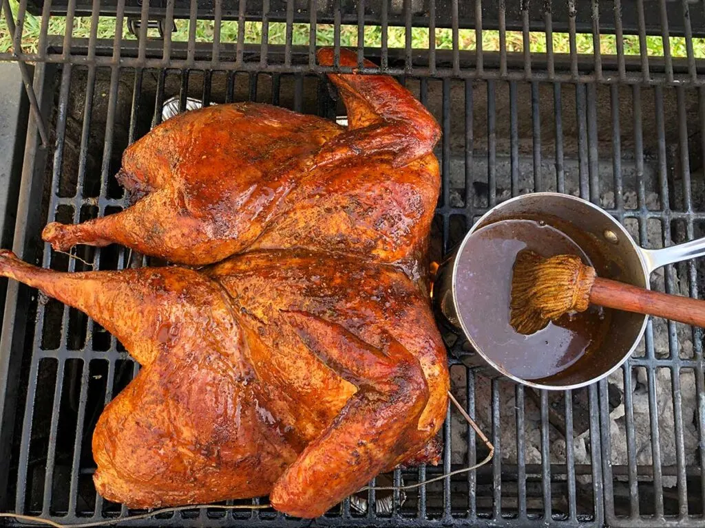 Turkey on grill with mop sauce