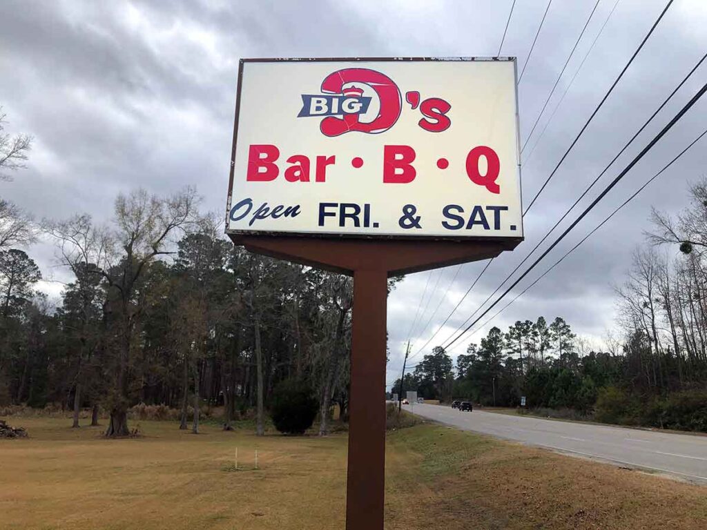 Big D's BBQ Barn sign standing beside Highway 41.