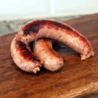 Onion Sausages on wooden cutting board