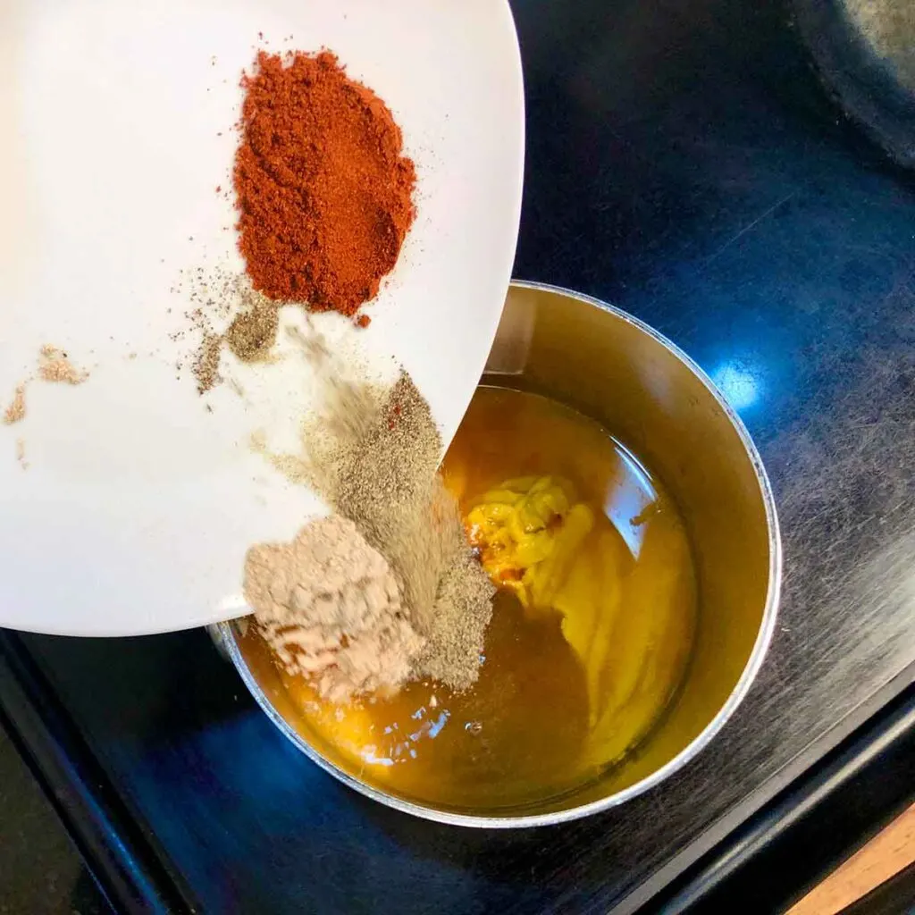 Adding Ingredients to saucepot to make Maurice’s BBQ Sauce Recipe