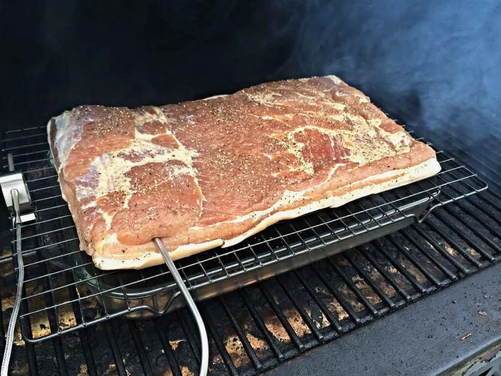 Cured pork belly in smoker.