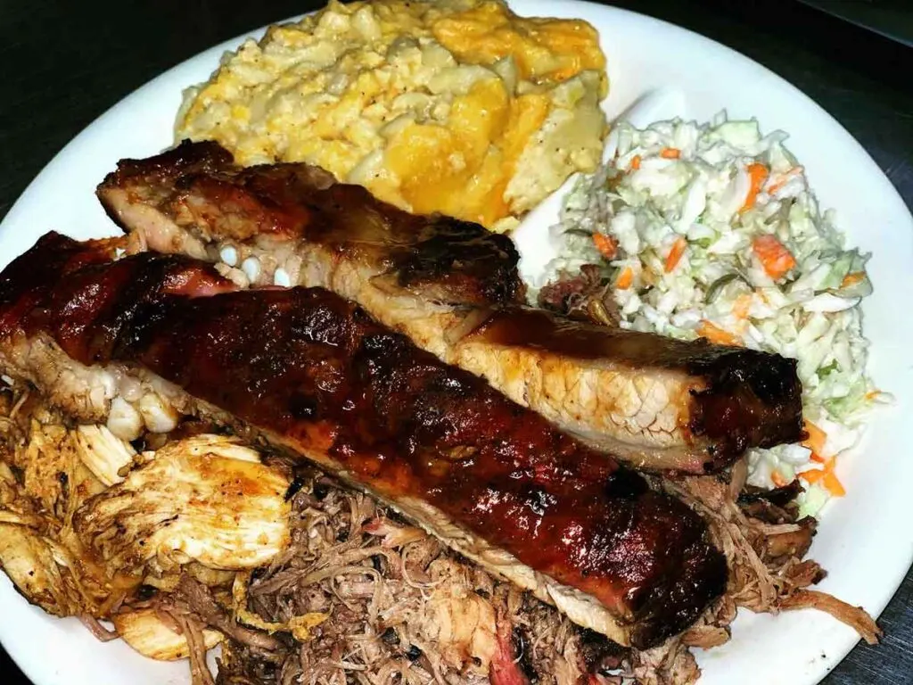 Ribs with pulled chicken and pork and two sides.