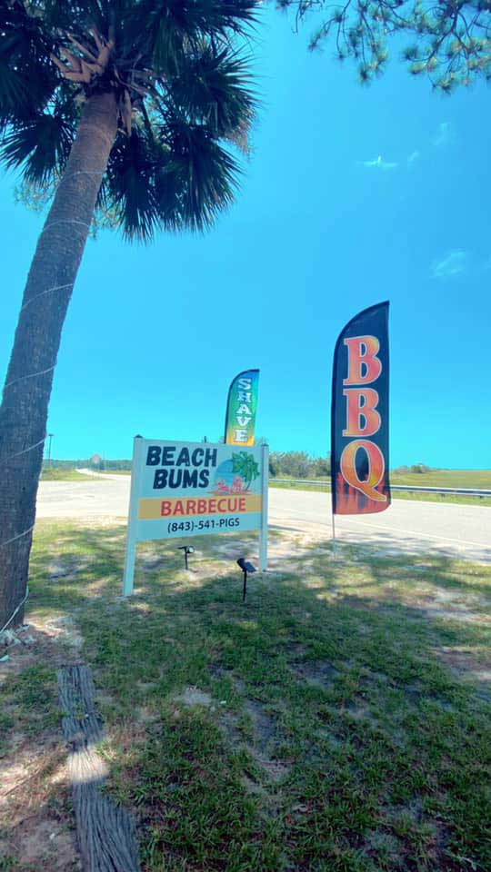 Signs beside road for Beach Bums Barbecue