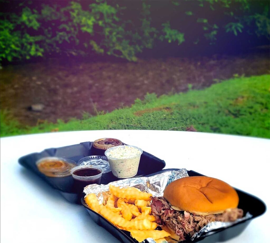 Brasstown BBQ sandwich tray with fries and slaw by the Creek