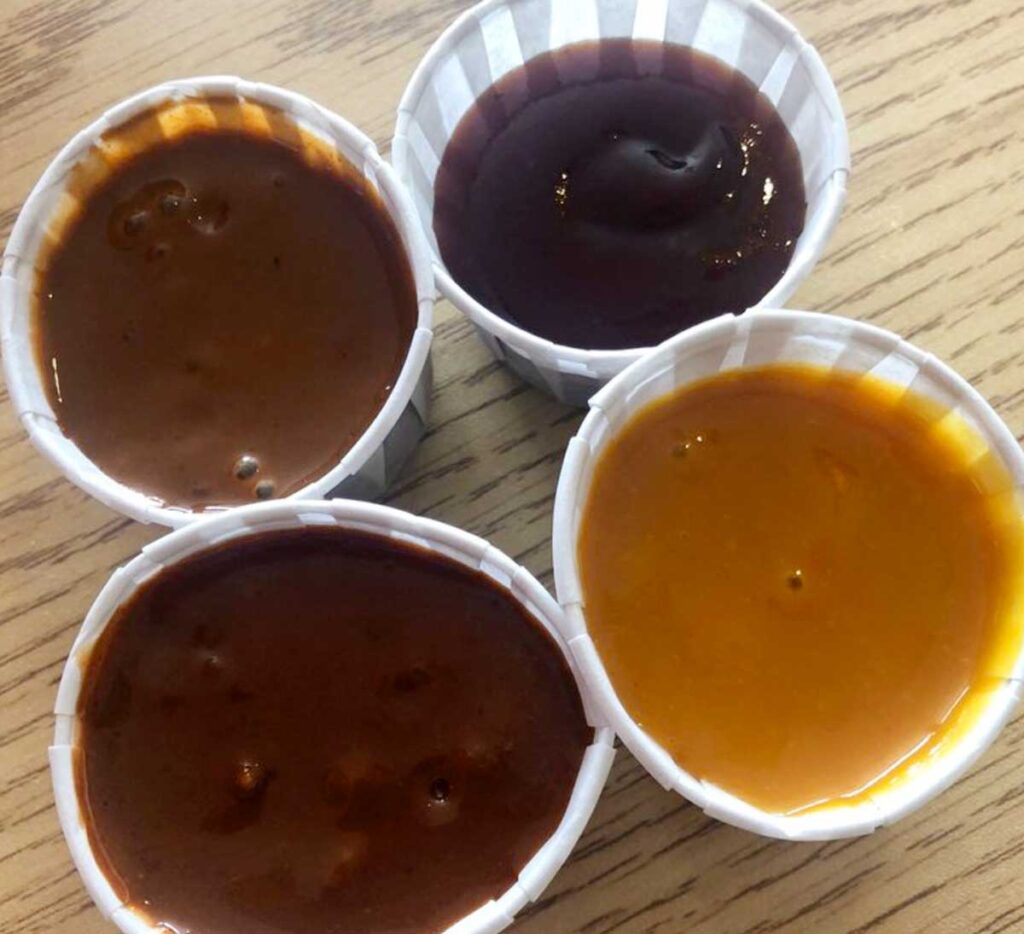 4 cups of different BBQ sauces