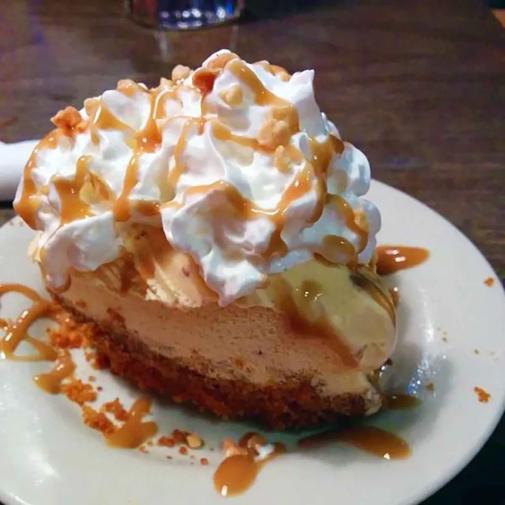 Slice of pie topped with whipped cream and caramel
