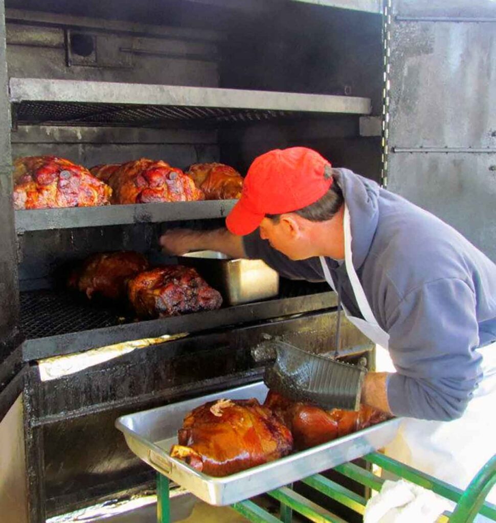 Steve Gardner cooking BBQ in the smoker.