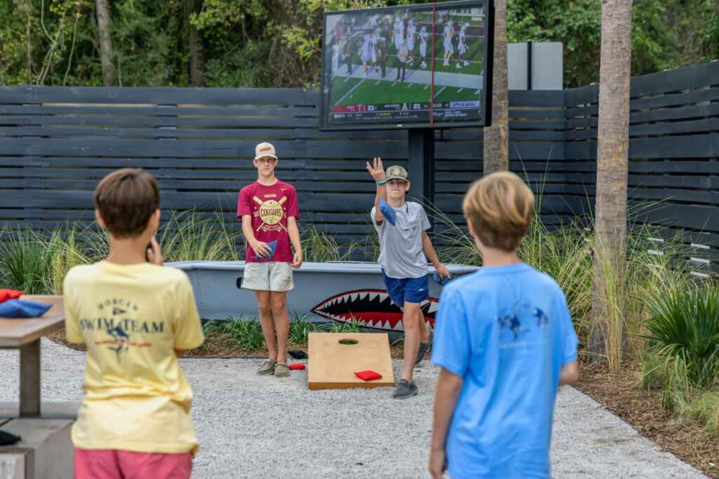 Kids playing corn hole at Home Team BBQ Mount Pleasant