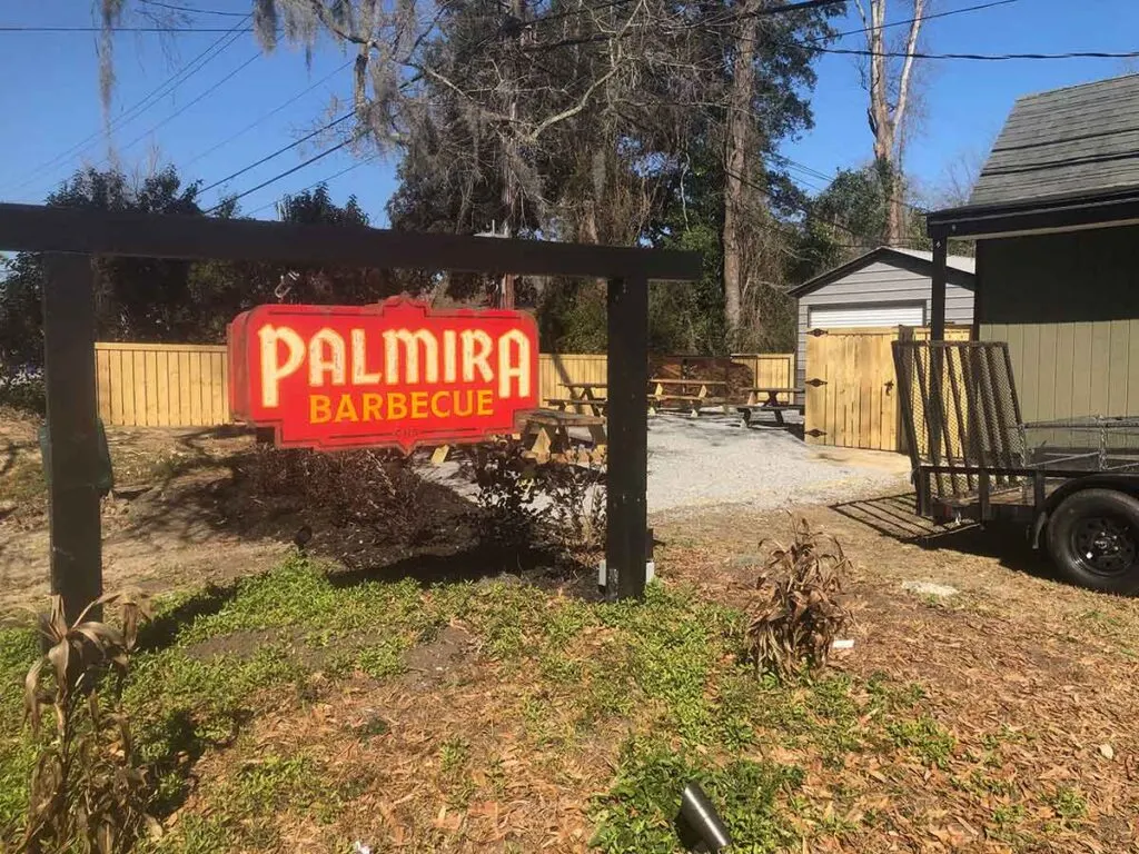 Palmira Barbecue sign and outside seating area.