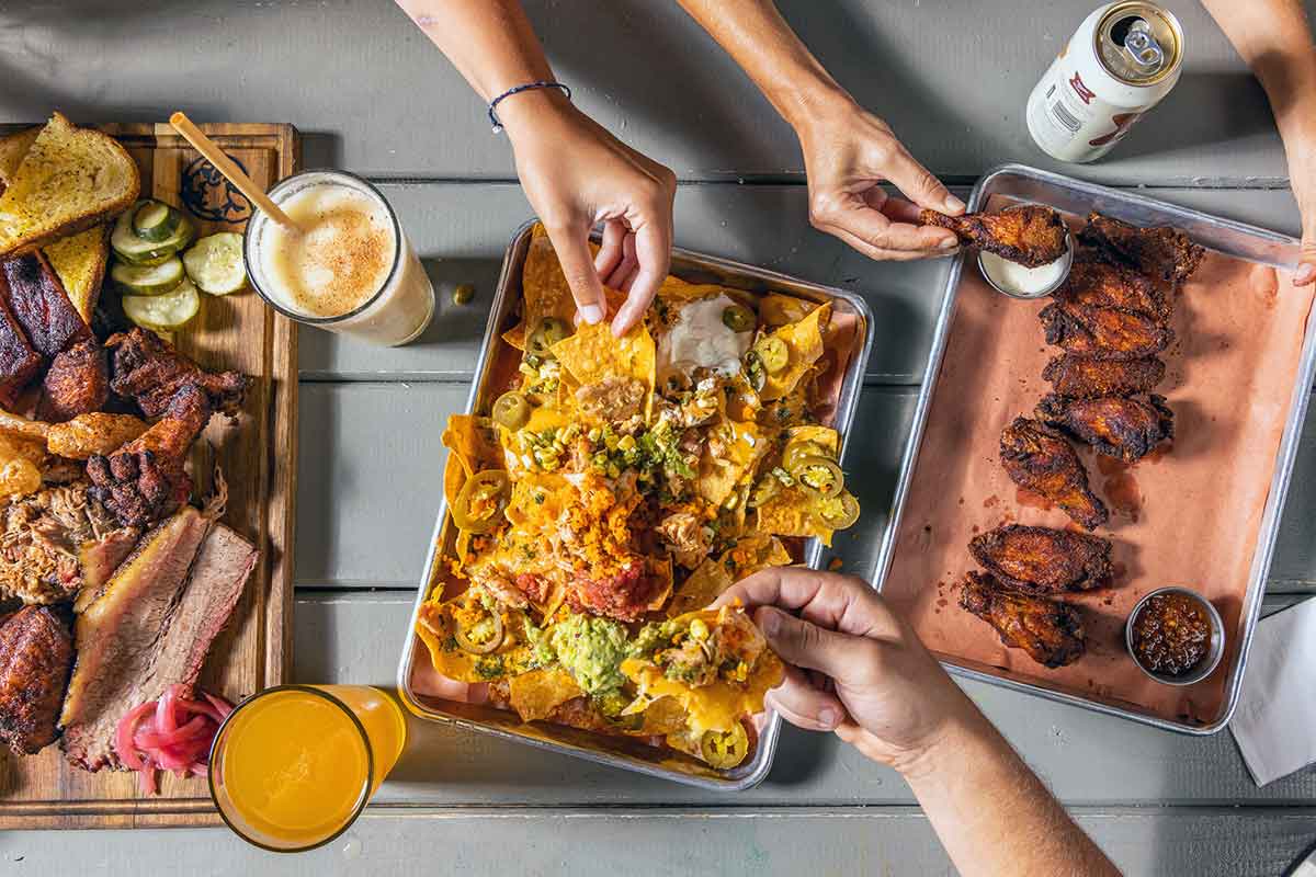 Overhead view of several trays of food.