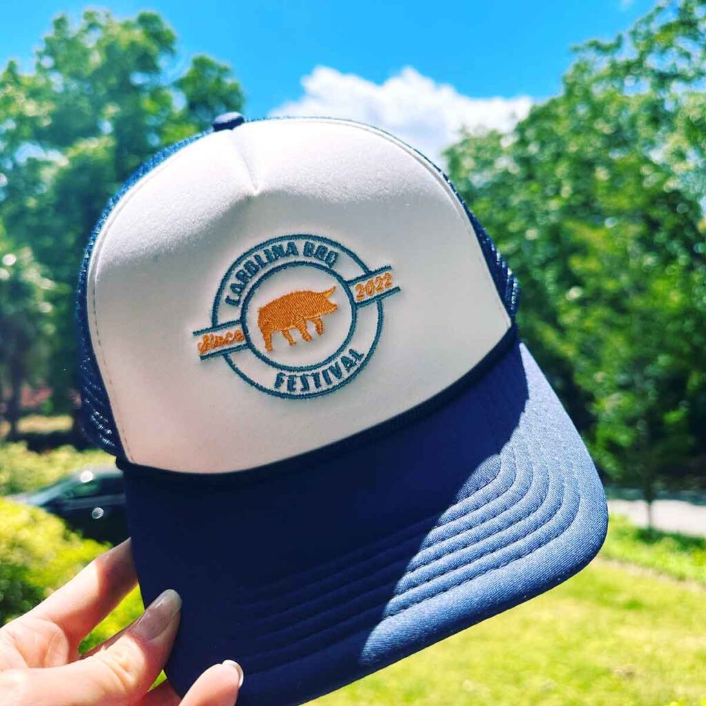 Blue and white hat with the Carolina BBQ Festival logo.