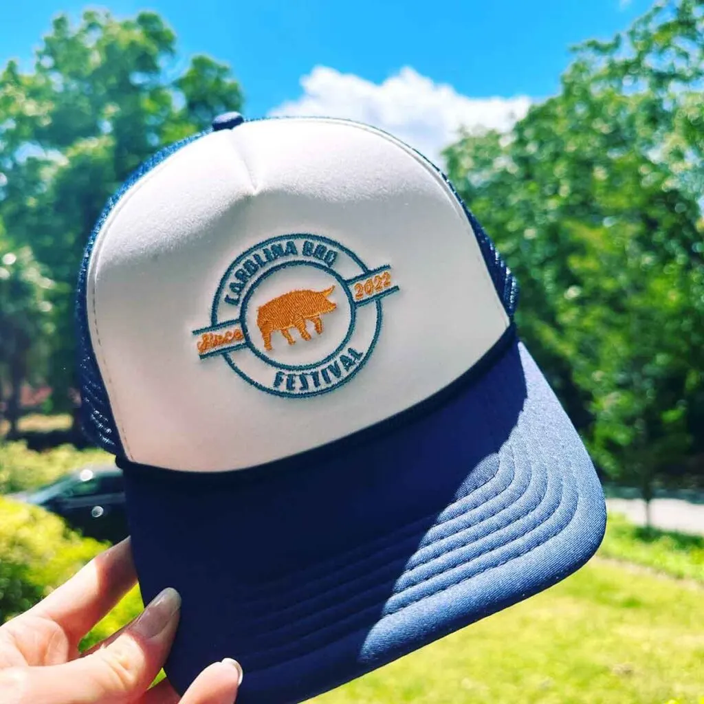 Blue and white hat with the Carolina BBQ Festival logo.