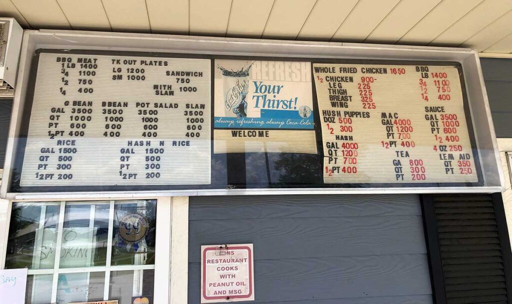 Menu for Antley's BBQ in Orangeburg hanging on outside wall by walk-up window.