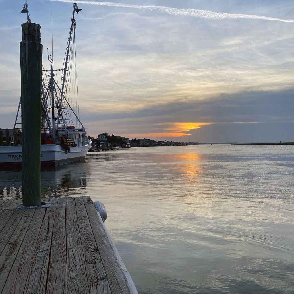 View from the dock of a shrimp boat at sunset.