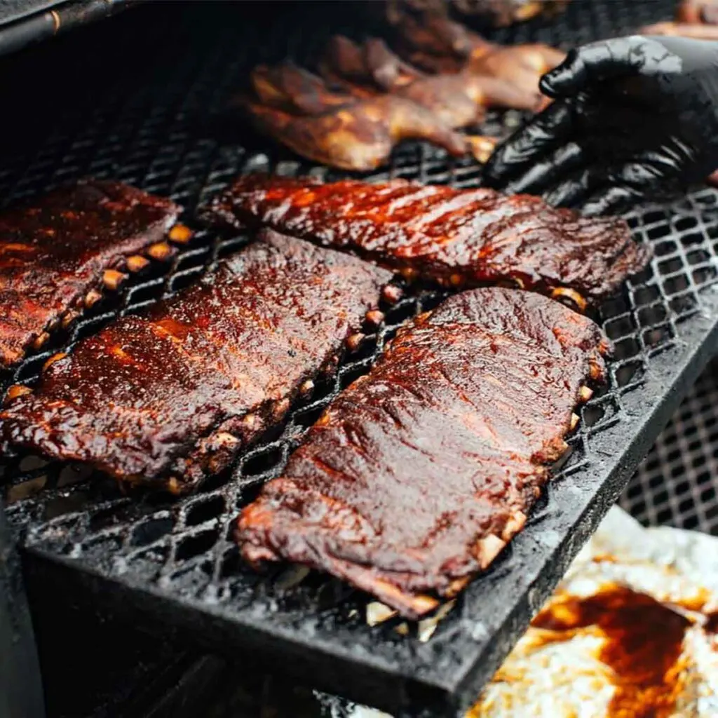 Racks of ribs on the grill.