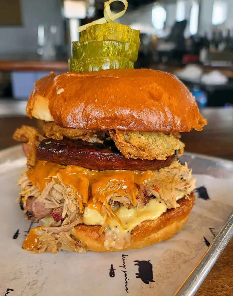 "The Big Stupid" at Briny Swine. Mac and cheese, brisket, pulled pork, chipotle mustard bbq, crispy onions, brioche bun.