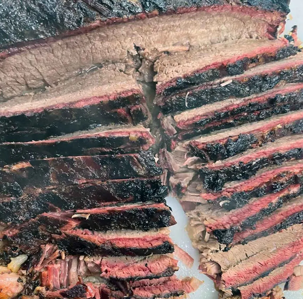 Brisket cut in slices showing smoke ring