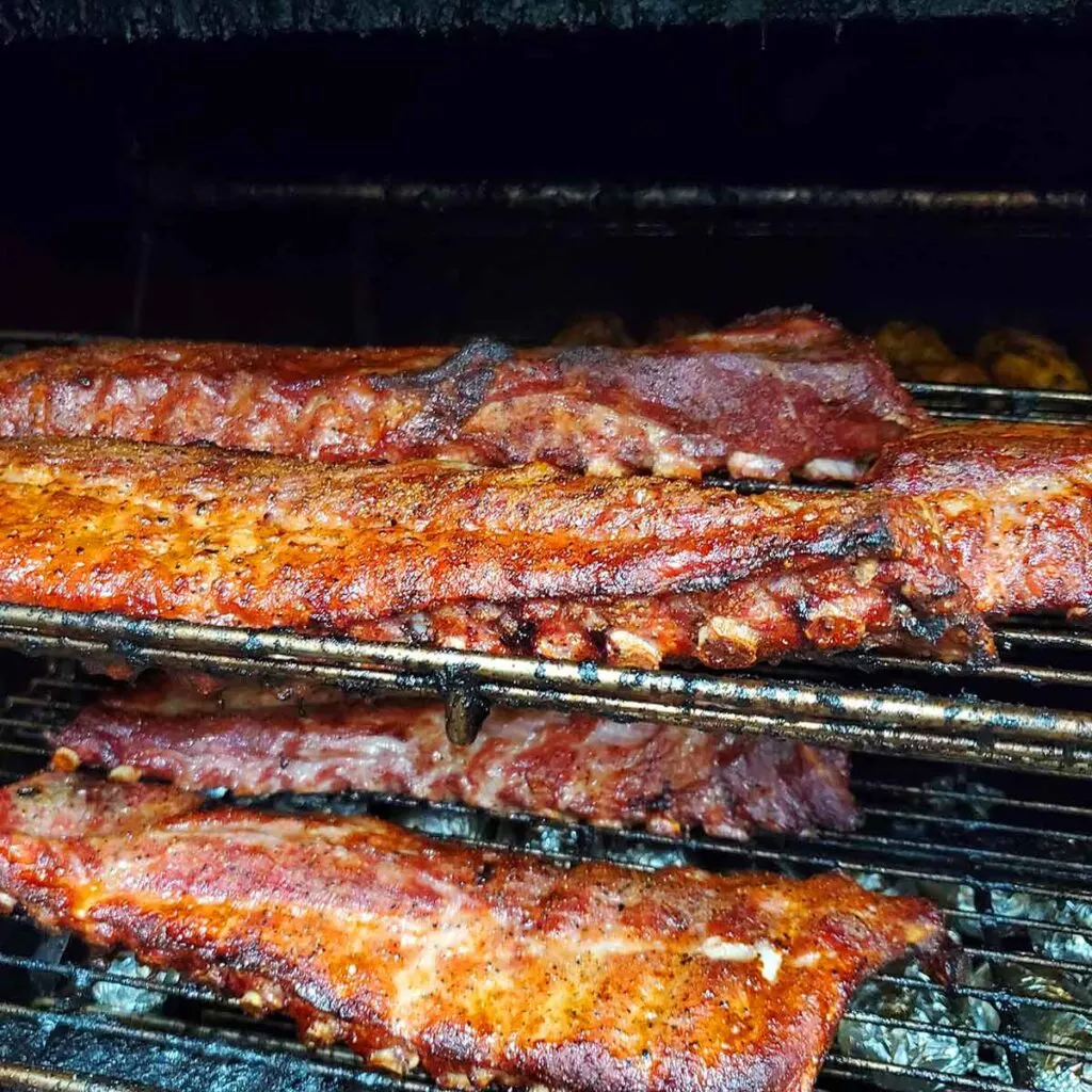 Racks of ribs on rotisserie cooker.