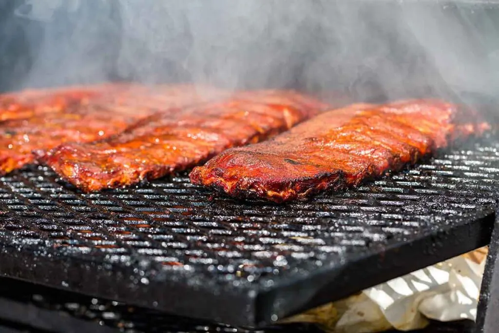 Ribs finishing on grill with thin blue smoke