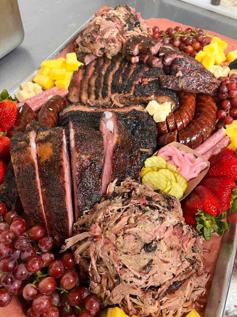 "Barbecuterie" board full of meats and fruits.