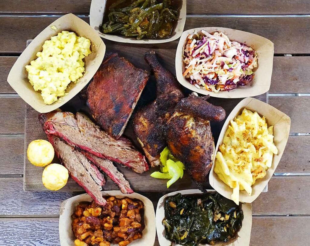 Top view of all the smoked meats and sides served by Forrest Fire BBQ.