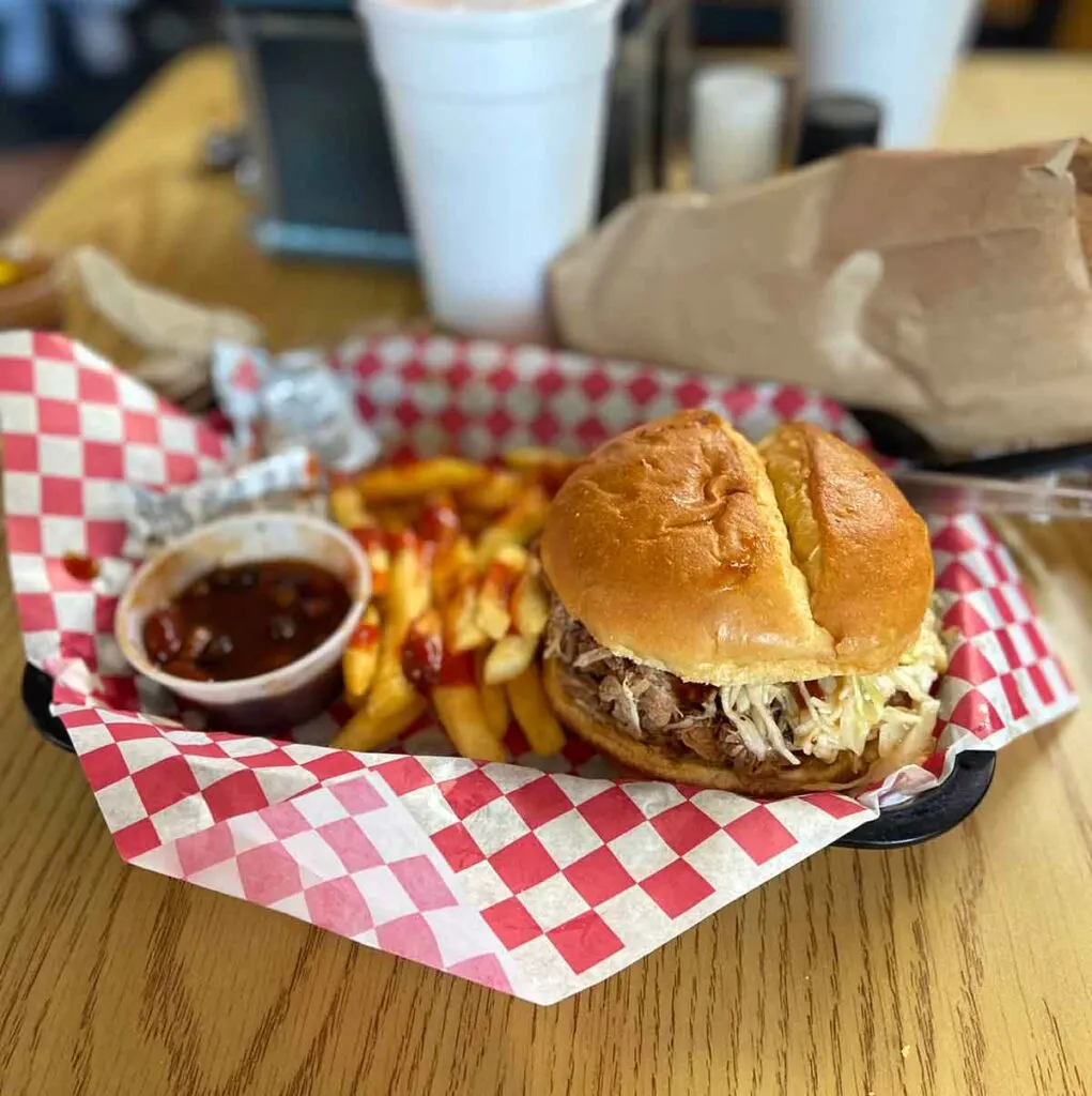 BBQ sandwich tray with fries and beans.