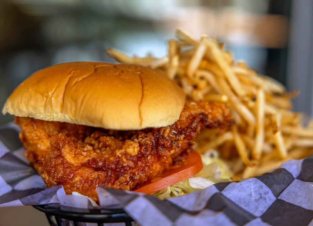 Honey chicken sandwich with fries.