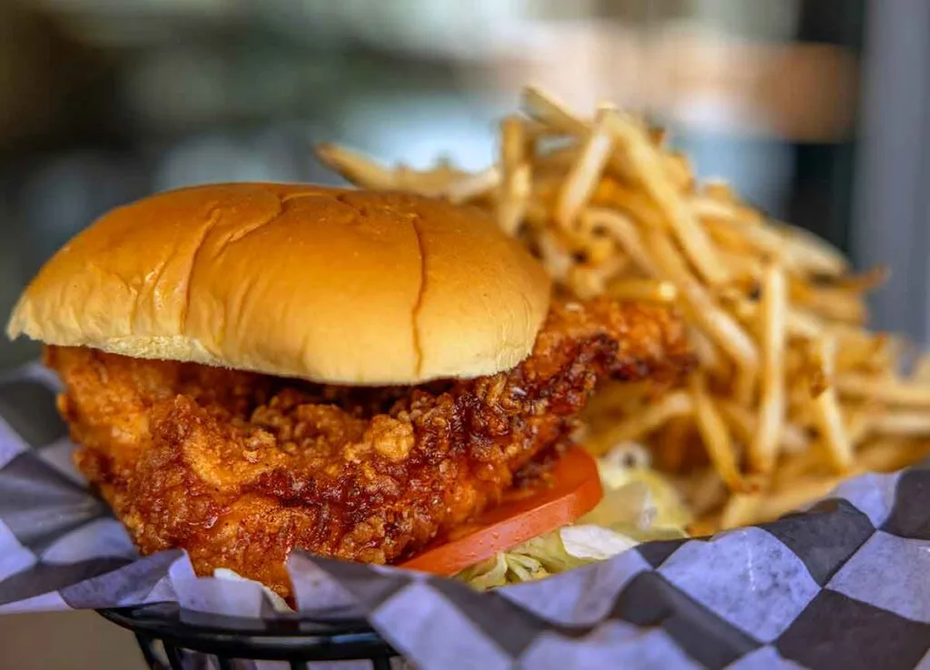 Honey chicken sandwich with fries.