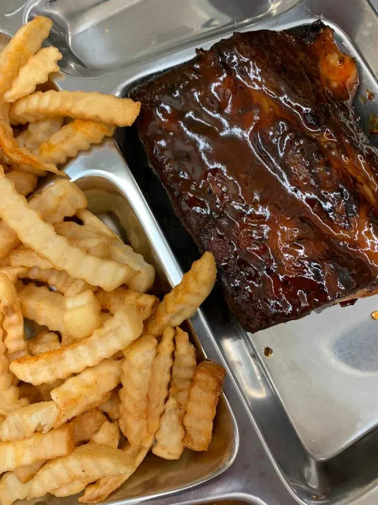 Ribs and fries on tray.