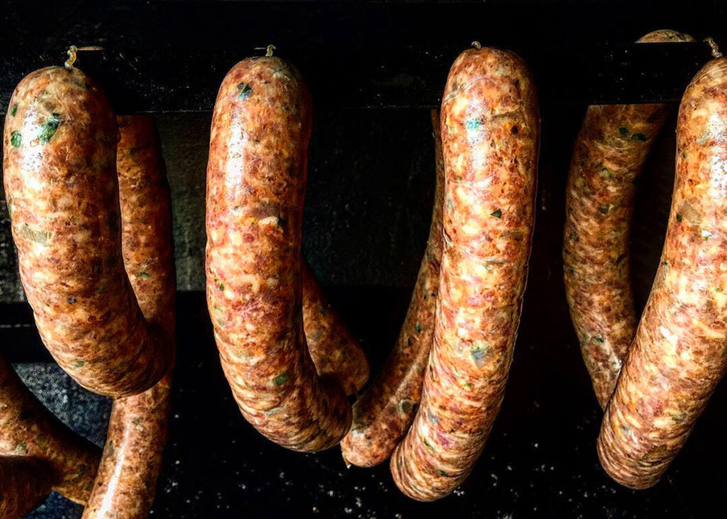 Sausages hanging in smoker.