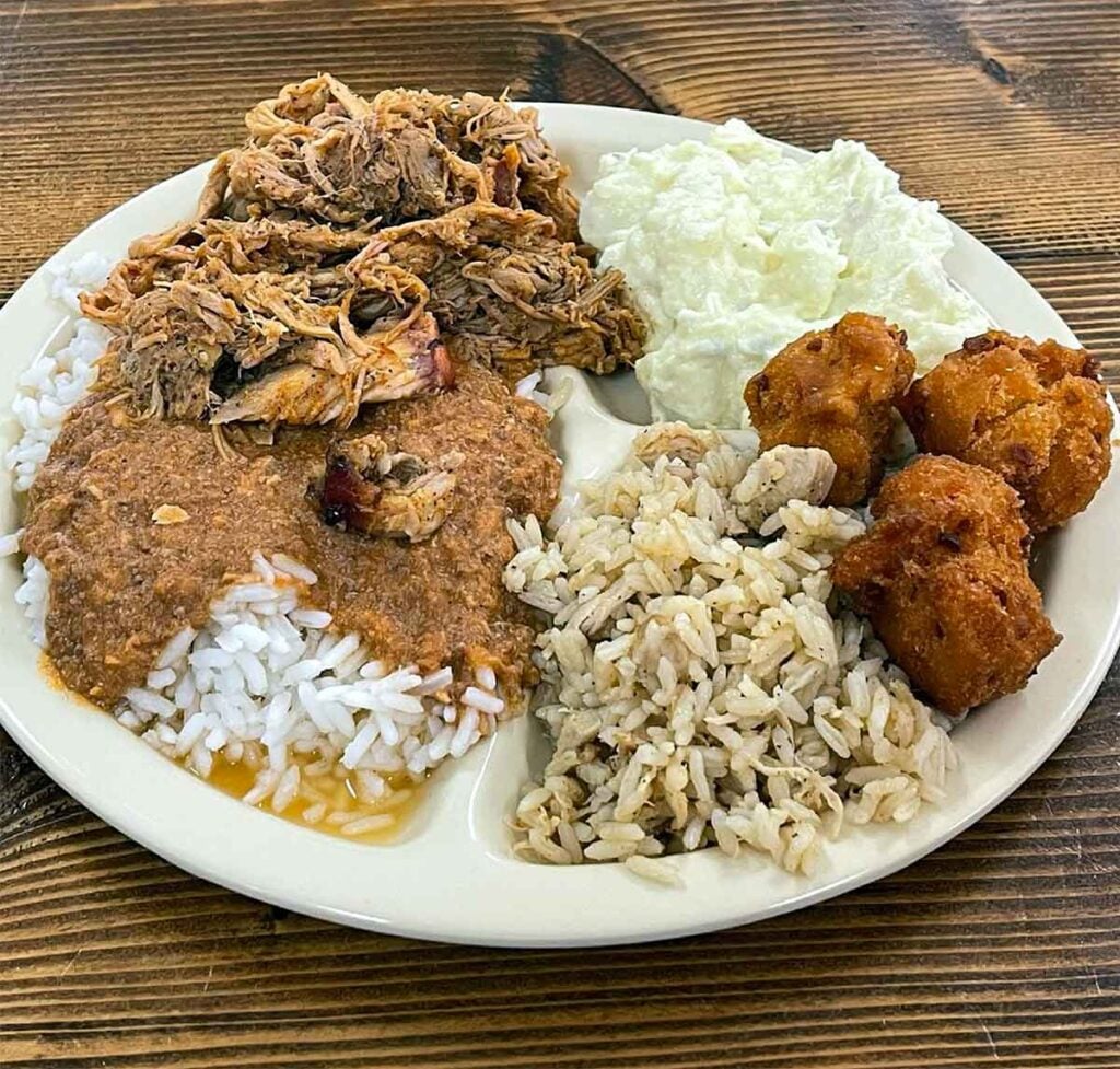 BBQ, hash, chicken bog, and more on styrofoam plate.