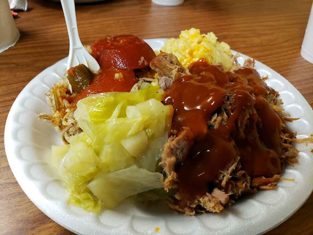 Red sauce on BBQ with sides.