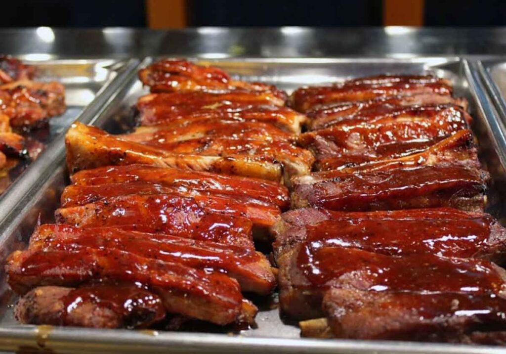 Pan of ribs on buffet table.