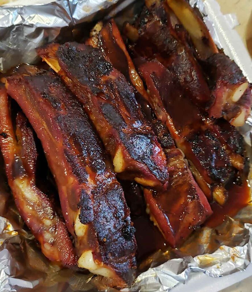 Close of up ribs in foil lined container.