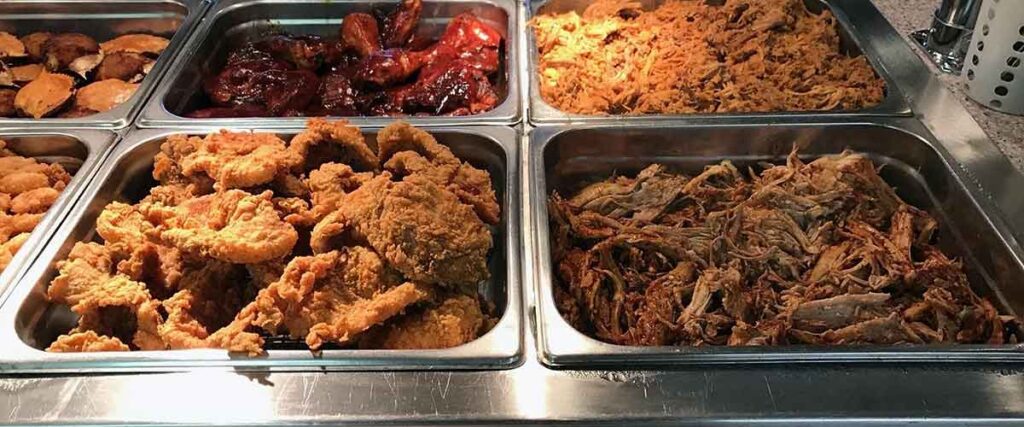 Trays of food on the buffet line at Woodstone.