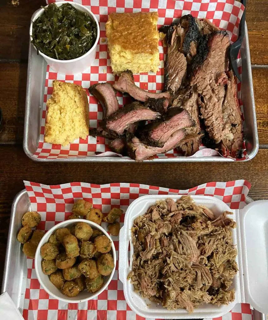 Selection of meats and sides on two trays.