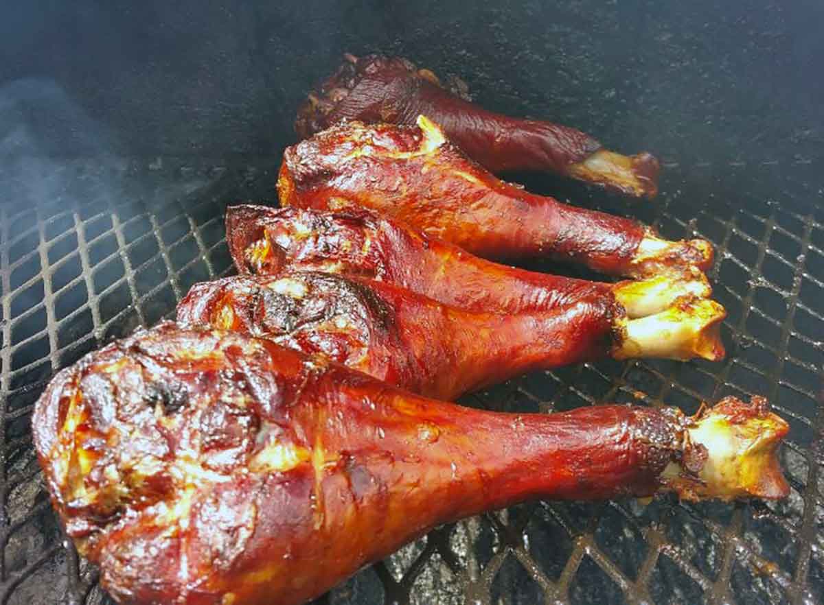 Smoked turkey legs on grill.