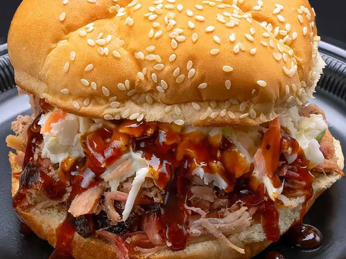 BBQ sandwich with slaw and sauce.