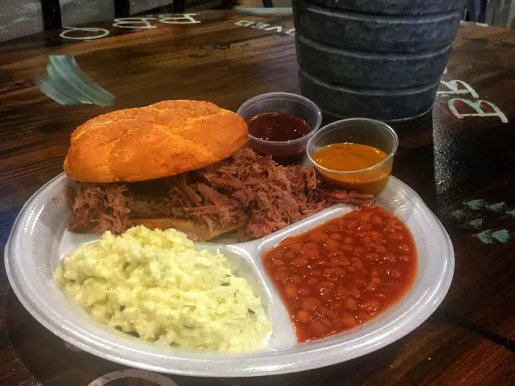 BBQ sandwich with slaw and baked beans.