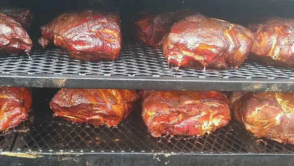 Several pork butts on the smoker.