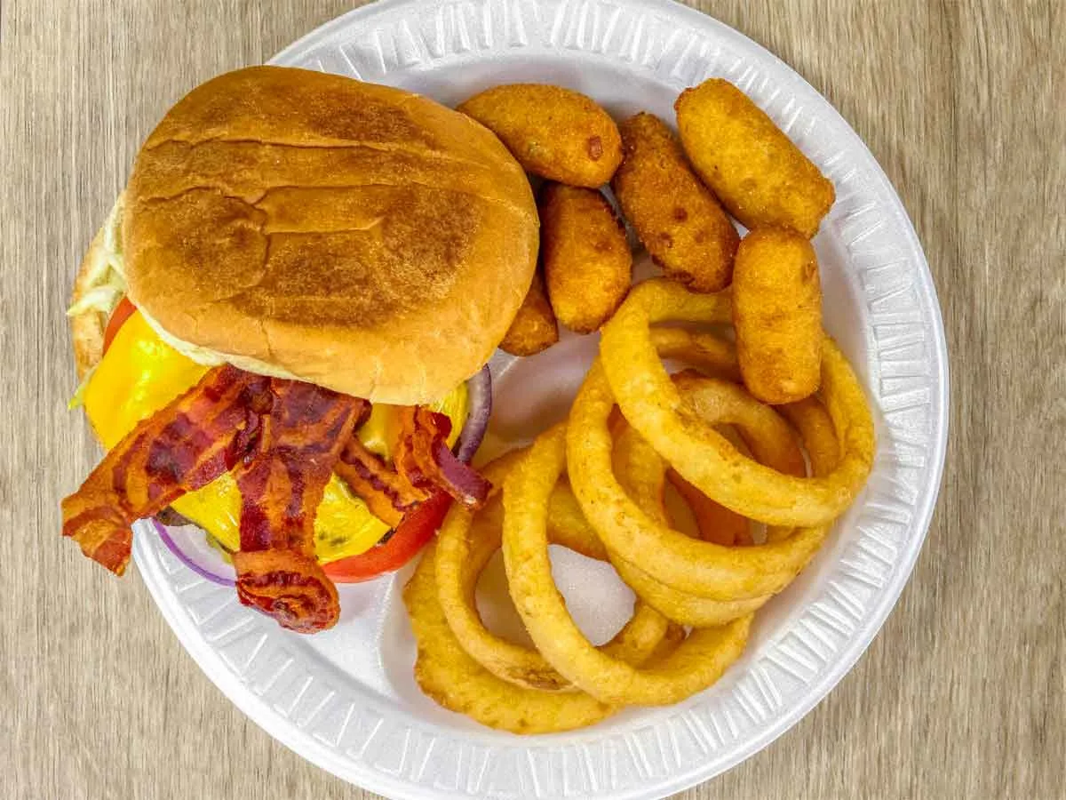 Bacon cheesburger with onion rings and hushpuppies.