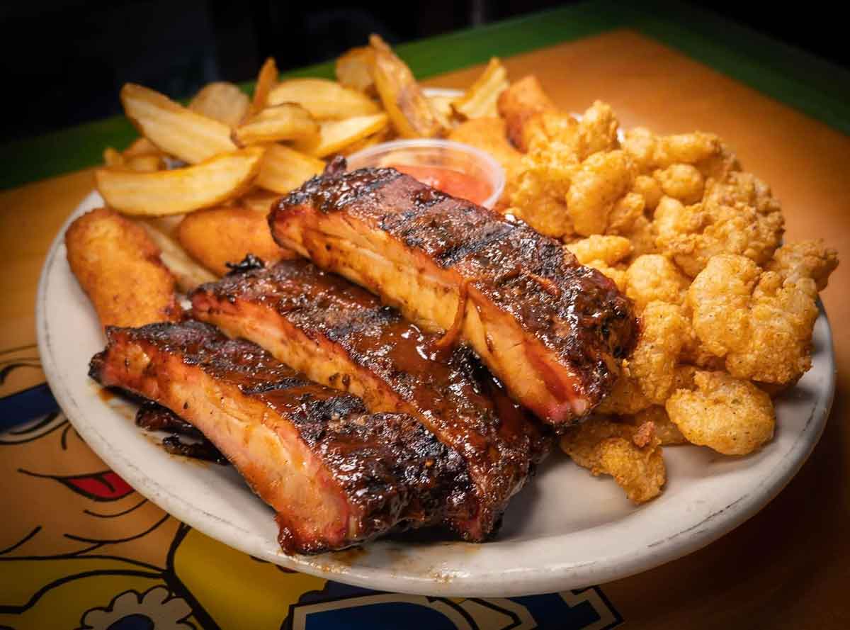 Ribs with fried shrimp and fries.