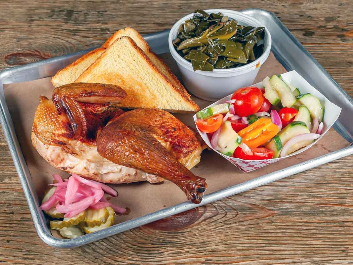 Smoked chicken half with sides.