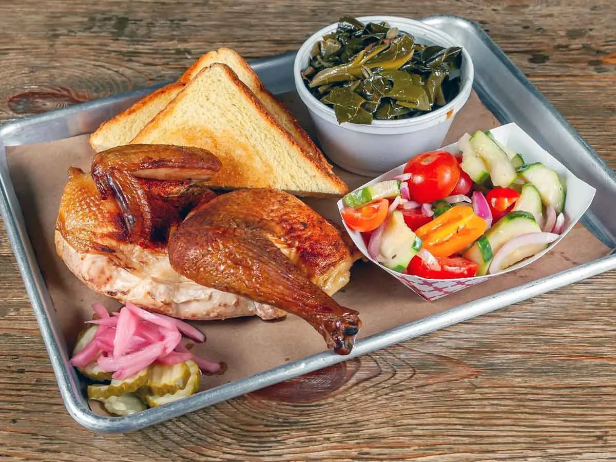 Smoked chicken half with sides.