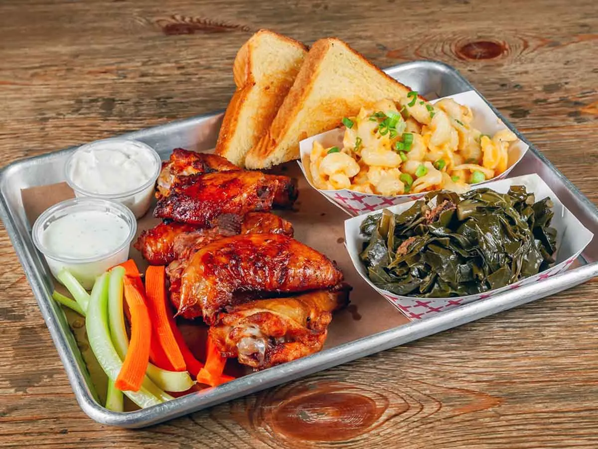 Smoked wings with sauce, collards, Mac and cheese, and toast.