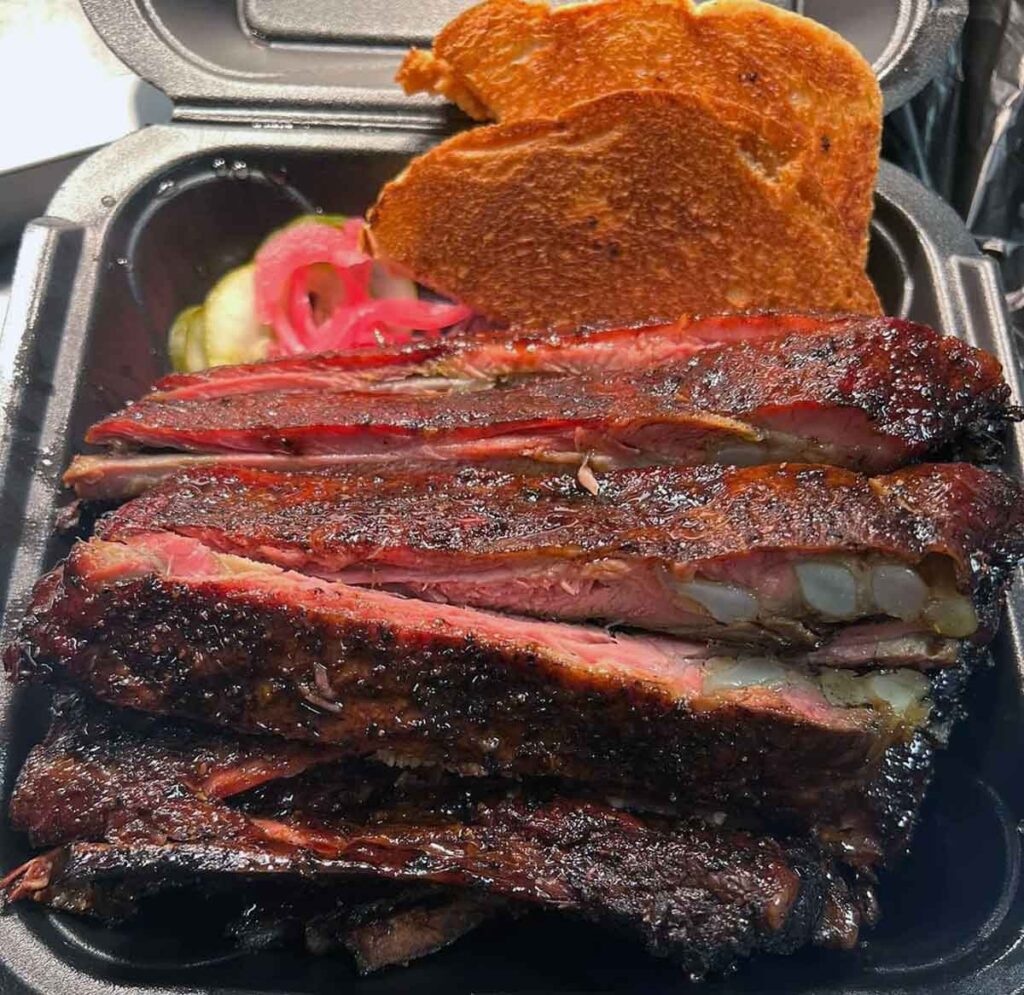 Takeout tray stacked with individual ribs.