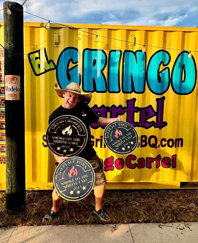 Brian posing with some of his many awards.