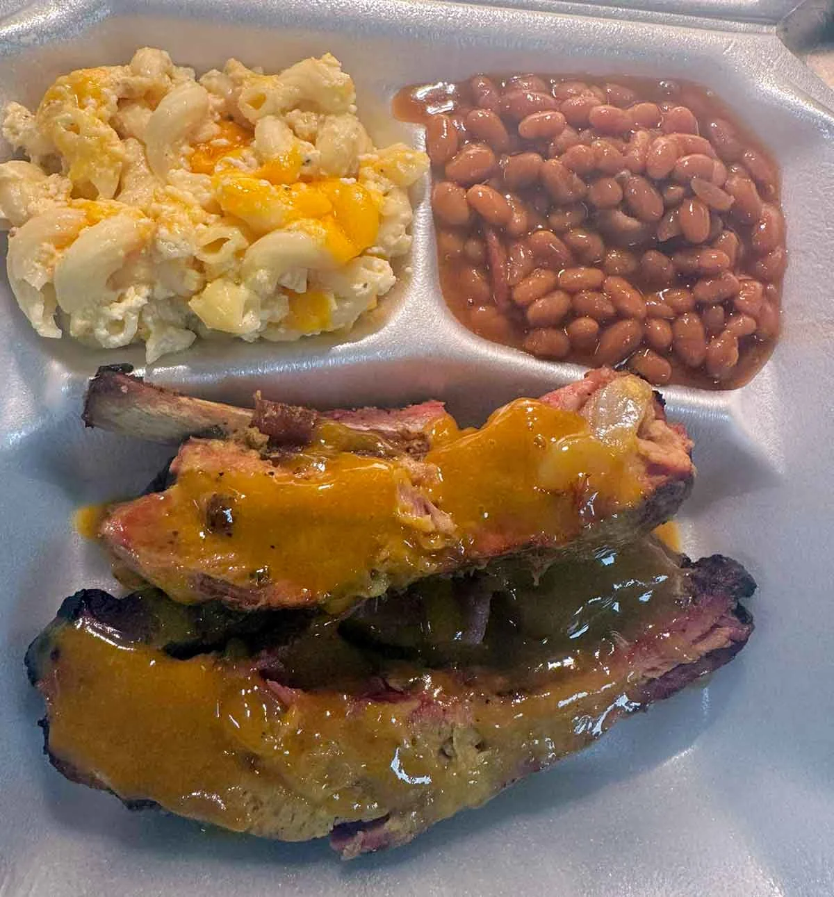 Rib plate with baked beans and Mac & cheese.