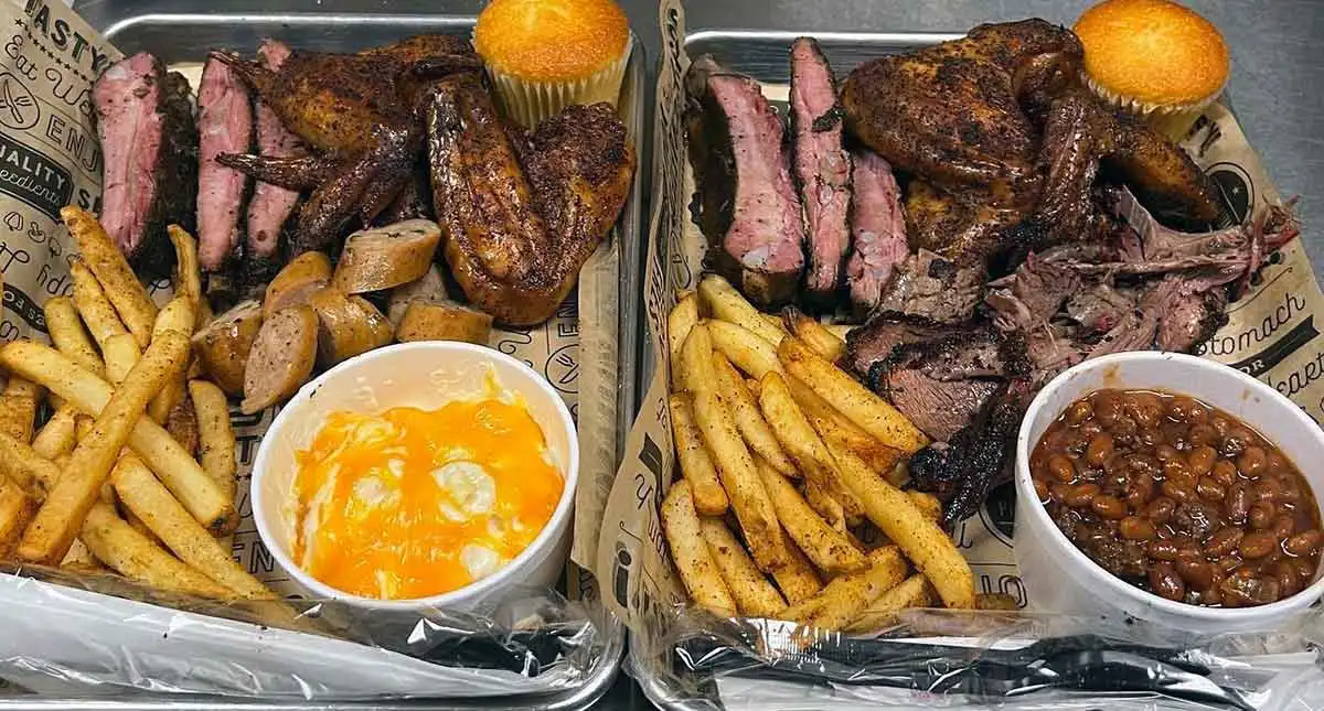 Two platters with meats and sides.